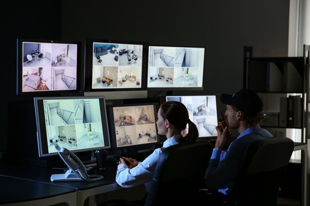 Security guards monitoring CCTV camera feeds, representing AI video surveillance