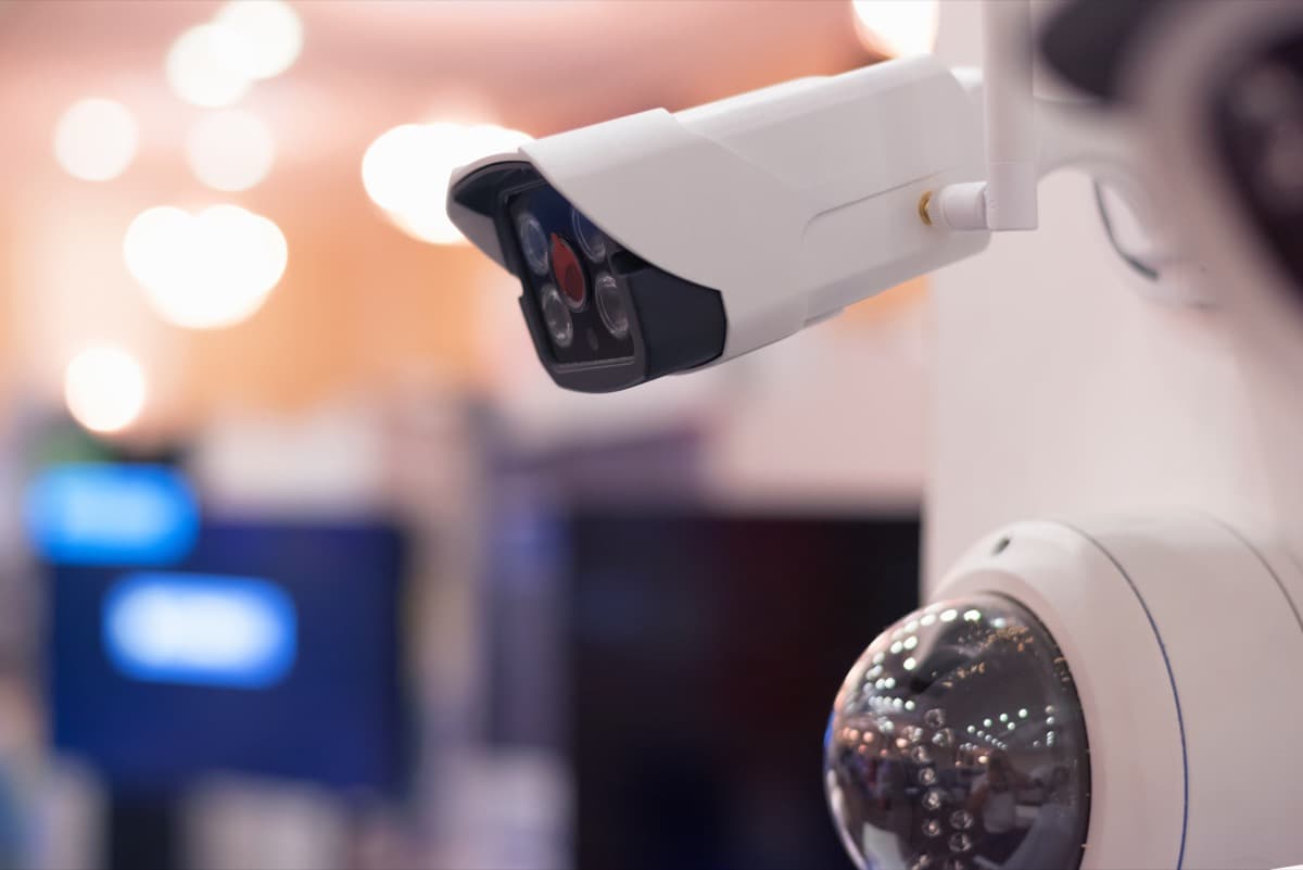 Close-up of commercial bullet and dome security cameras in a modern building