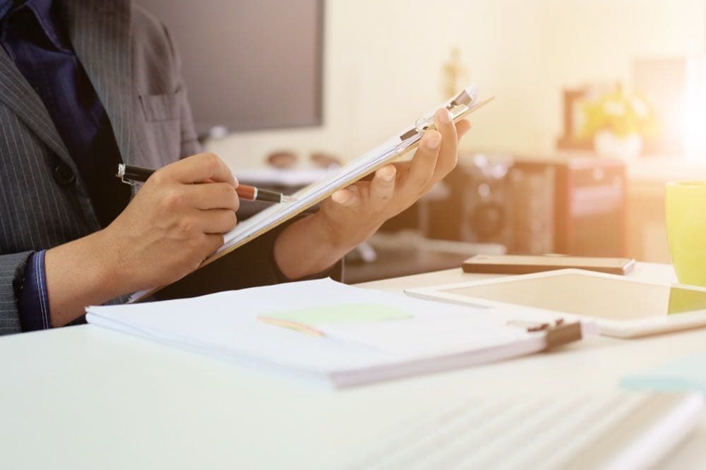 Audit checklist on a document board, representing SOC 2 multi-framework compliance mapping