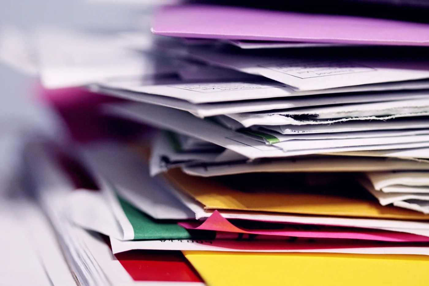 Stack of paper documents and colored folders