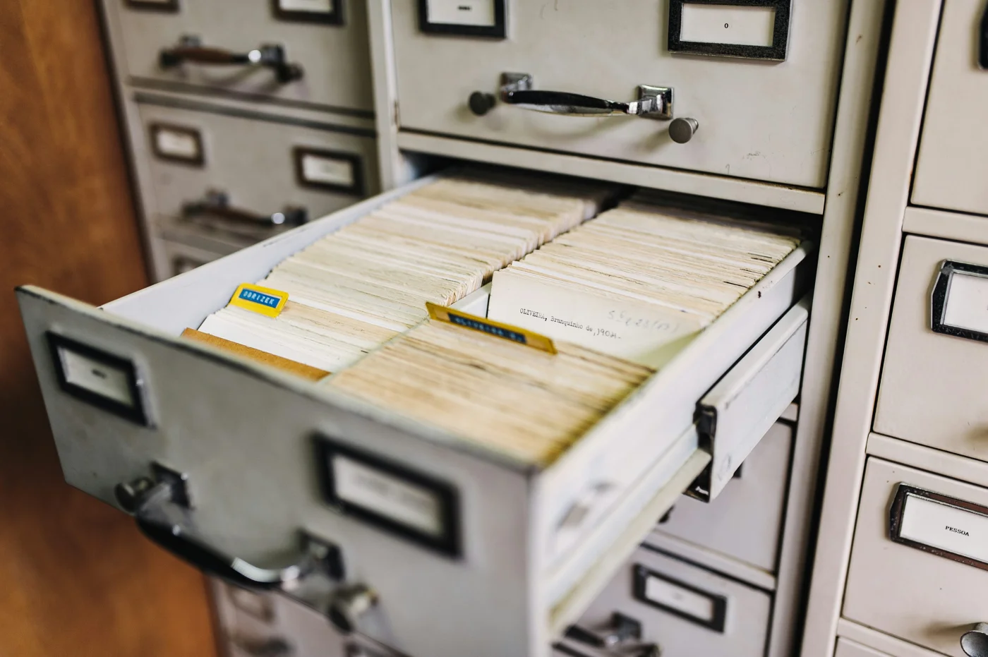 Open filing cabinet holding organized paper records