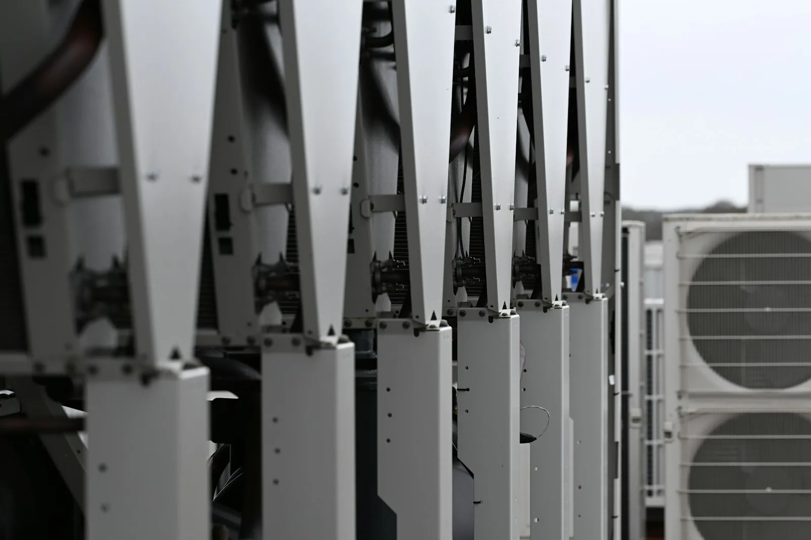 Outdoor mechanical equipment with a row of rooftop heating and cooling units.
