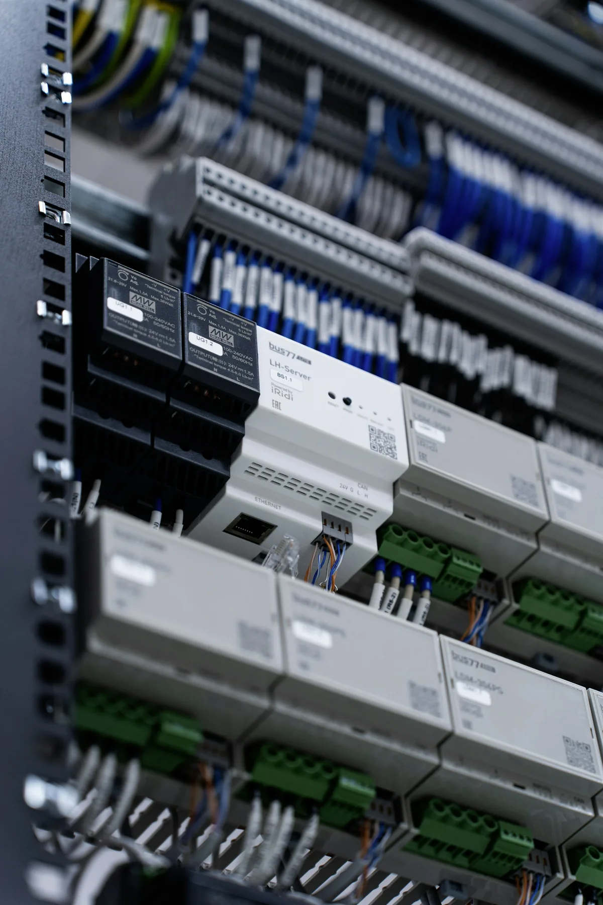 Modular control equipment and neatly routed wiring inside an electrical cabinet.