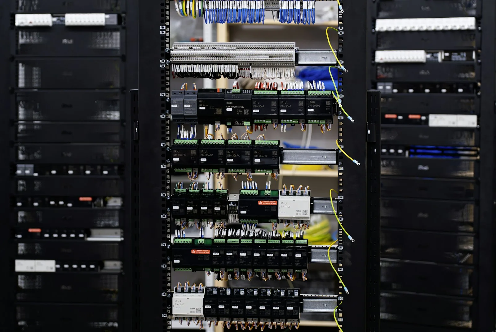 Open electrical control cabinet with terminal blocks, circuit breakers and organized wiring.