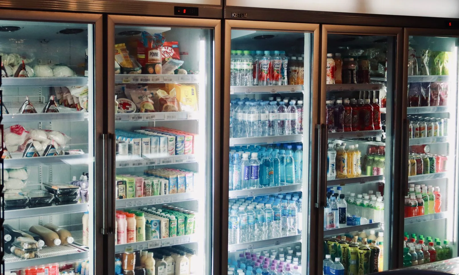 Glass-front refrigerated cases stocked with food and bottled drinks.