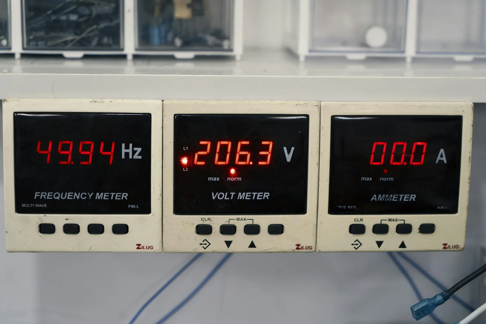 Panel-mounted digital electrical instruments with illuminated numeric readouts.