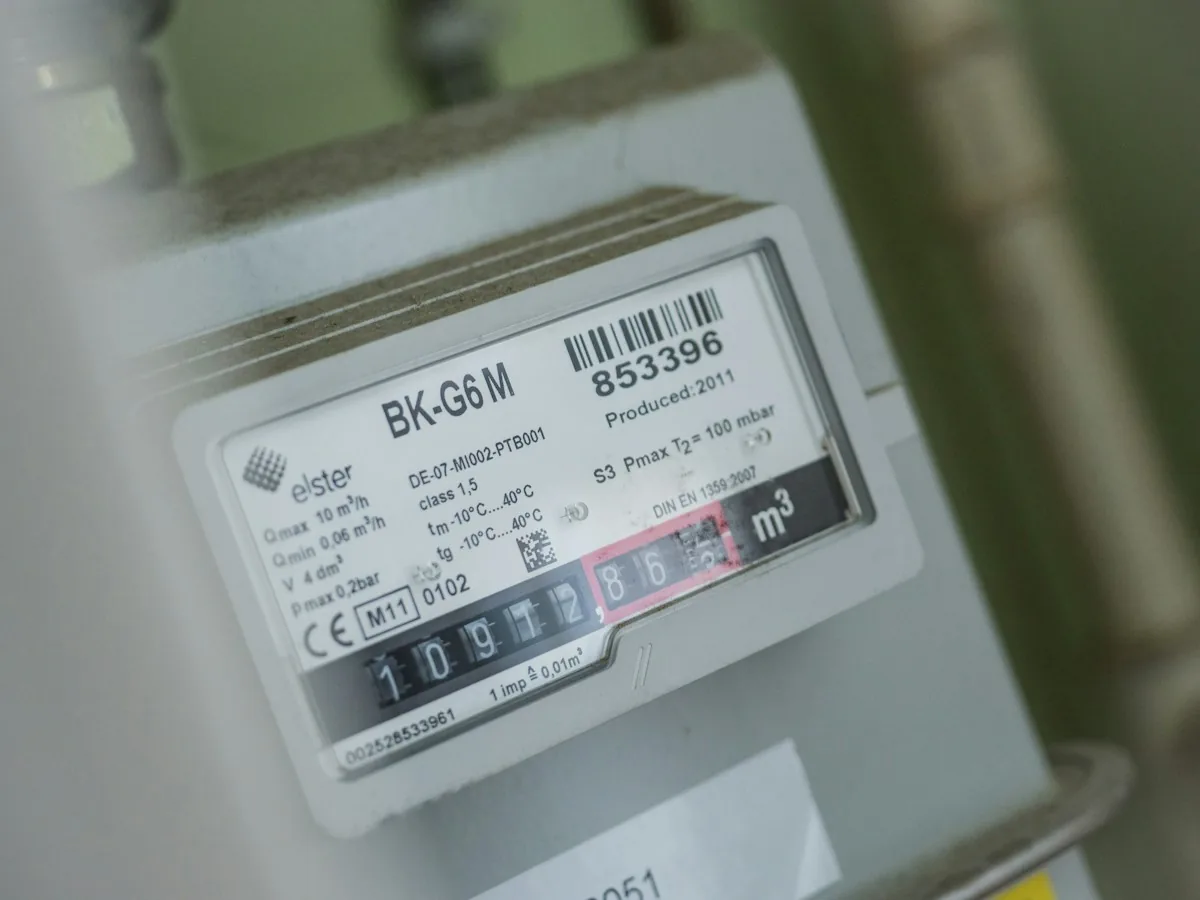 Close-up of a gas meter with a mechanical number register and printed identification label.