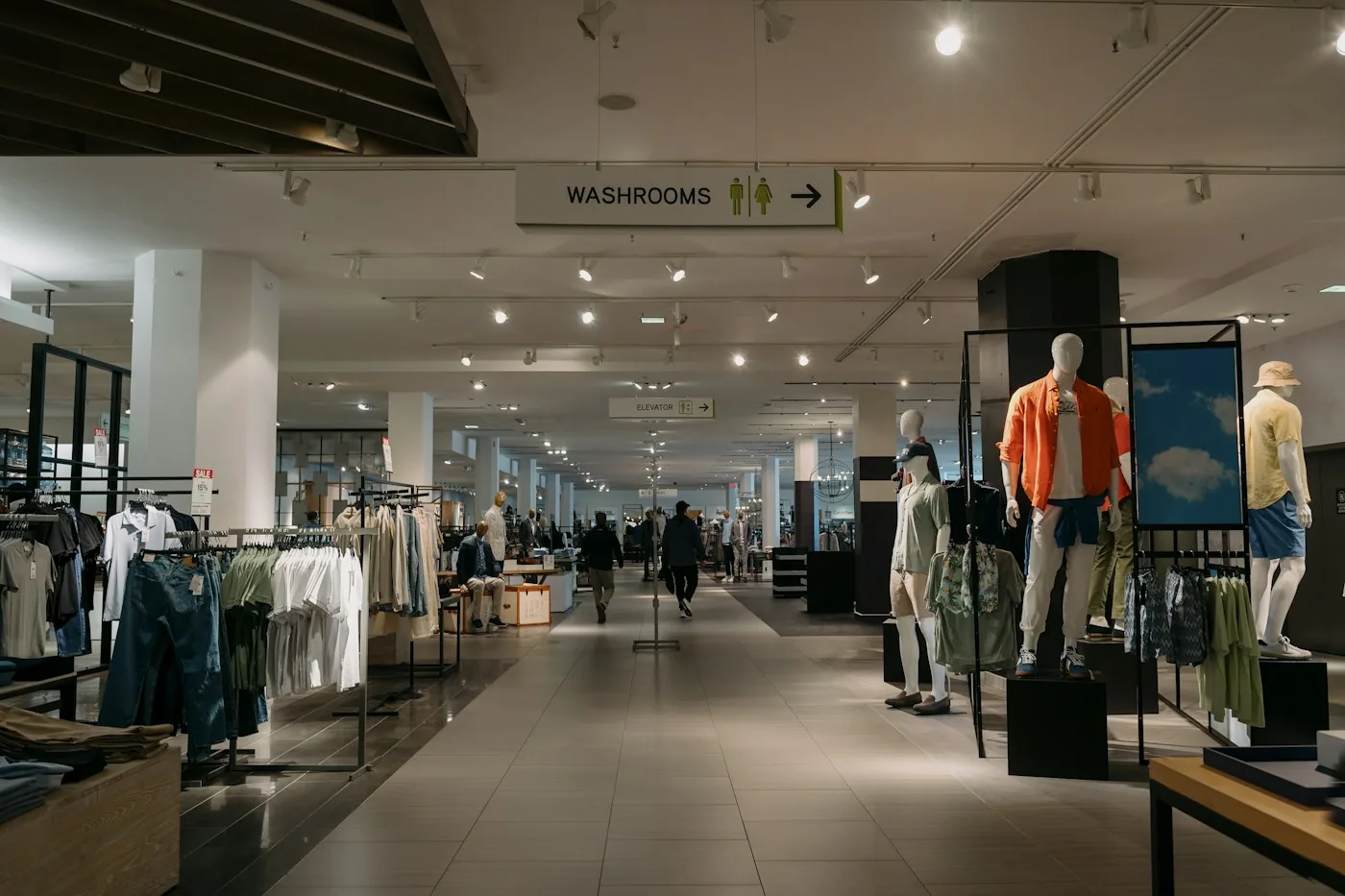 Clothing displays and a clear central aisle inside a retail store.
