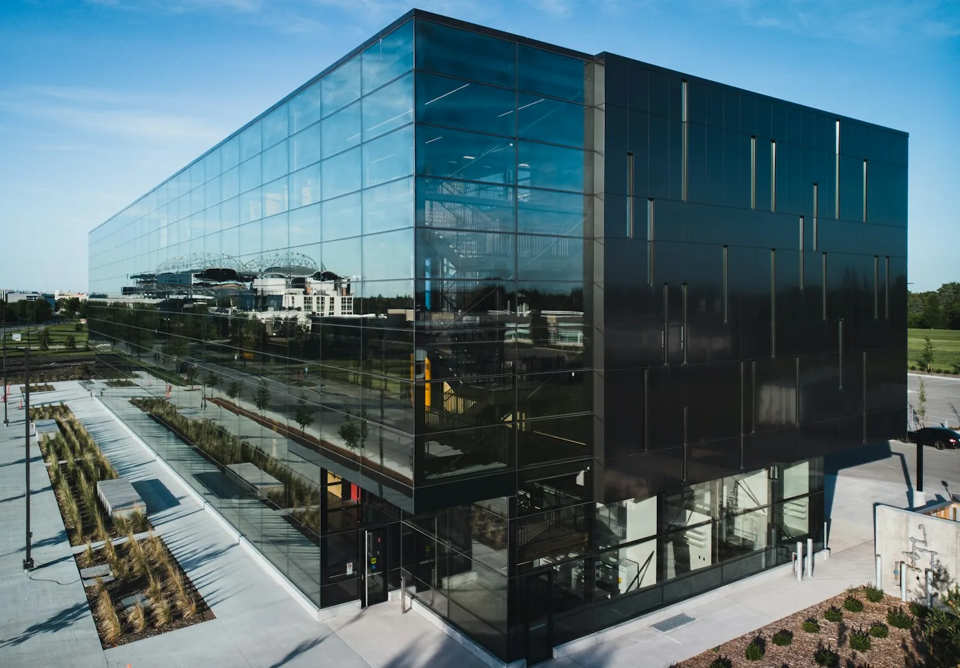 Glass-fronted office building and landscaped entrance paths.