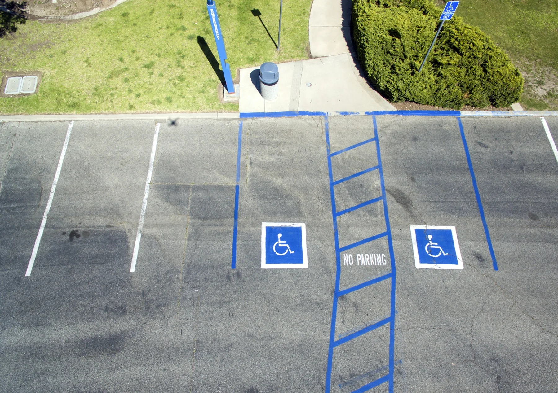 Two accessible parking bays with blue markings and a striped access aisle.