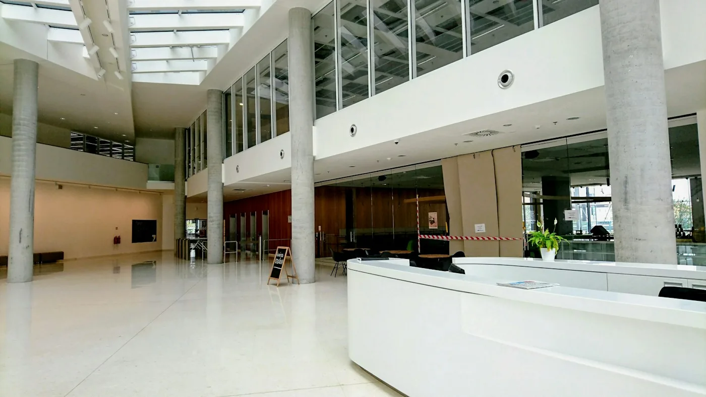 Large public lobby with a curved reception counter and several interior approaches.